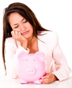 Sad woman with piggy bank