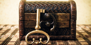 locked wooden chest with key propped against it
