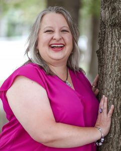Christina Ammerman leaning against tree