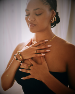 woman with eyes closed, hands over heart