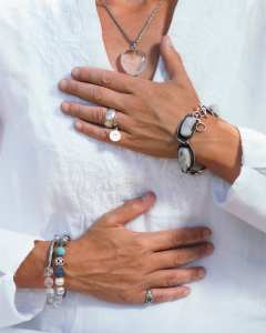 closeup of women placing her hands on her heart and bellly