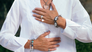 closeup of women placing her hands on her heart and bellly
