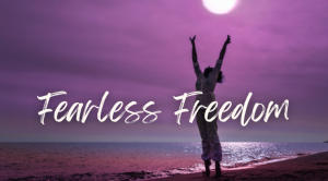 words 'Fearless Freedom' in front of woman reaching arms up, silhouetted against purple sky