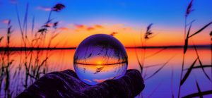 person holding ball during sunset