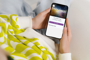 close-up of person holding phone that displays the Daily Energy Tools program