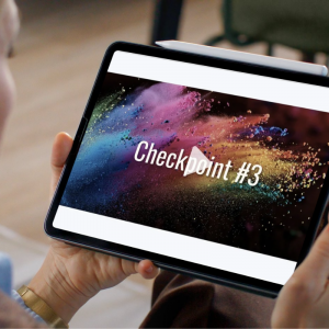 close-up of hands holding a tablet which shows the video for Fearless Freedom Checkpoint #3