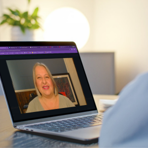 close-up of laptop showing a video call with Christina