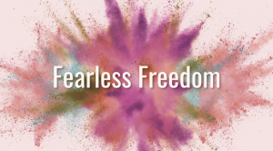 words 'Fearless Freedom' in front of abstract explosion of colors on white background